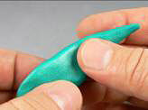Blue clay being shaped